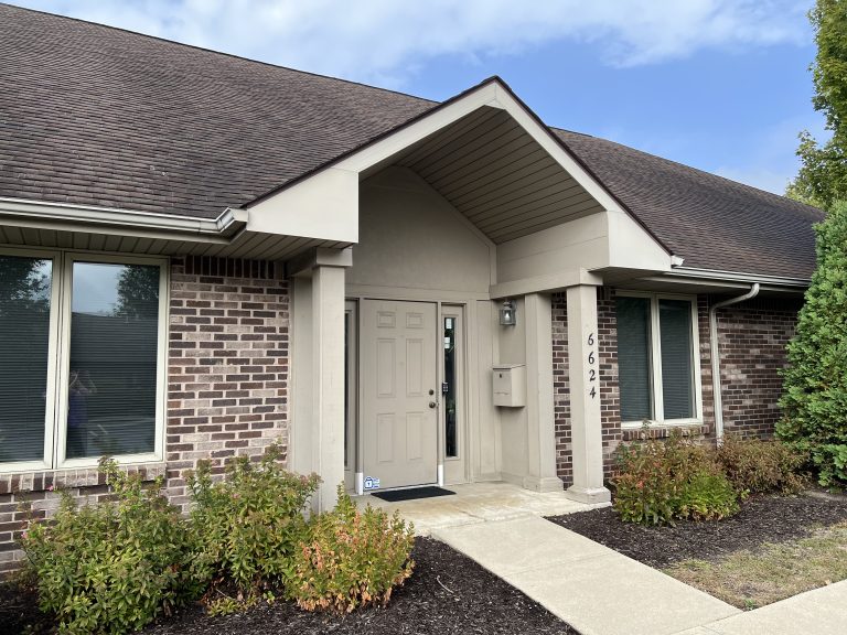 Inviting office building that looks like a home and has a front door.